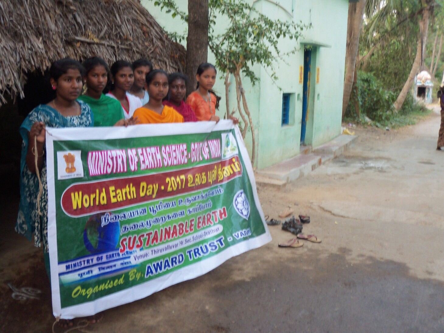 Young women from a Cuddalore village holding an AWARD TRUST community awareness banner